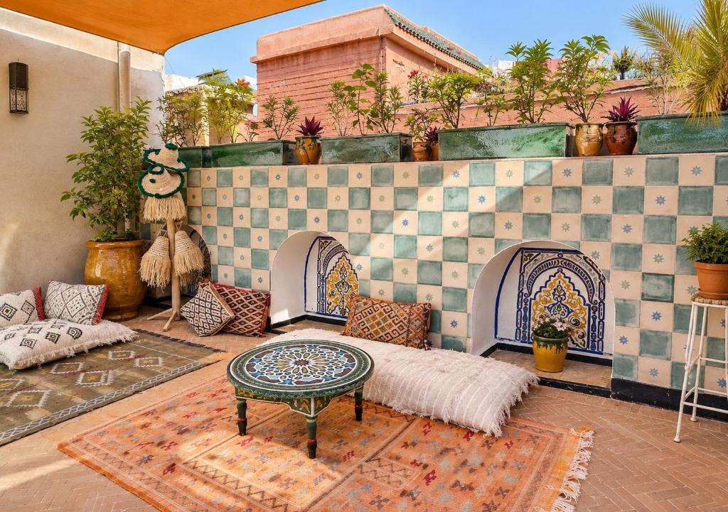 Moroccan craft, Riad Hna Ben Saleh, Marrakech Rooftop lounge with zellige tiles, Berber cushions and a painted table, Riad Hna Ben Saleh, Marrakech